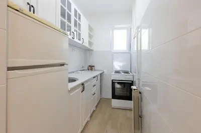 a white kitchen with a sink and a stove at Belgrade Center Apartment Admiral in Belgrade