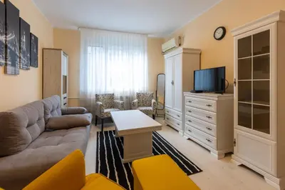 a living room with a couch and a tv at Belgrade Center Apartment Admiral in Belgrade