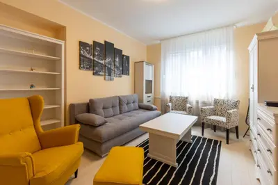 a living room with a couch and a table and chairs at Belgrade Center Apartment Admiral in Belgrade