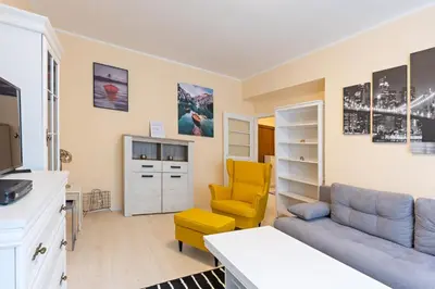 a living room with a couch and a yellow chair at Belgrade Center Apartment Admiral in Belgrade
