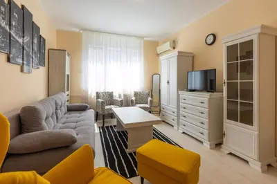 a living room with a couch and a tv at Belgrade Center Apartment Admiral in Belgrade