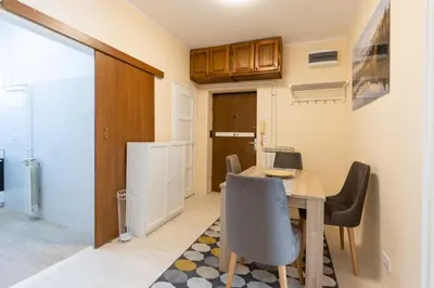 a kitchen and dining room with a table and chairs at Belgrade Center Apartment Admiral in Belgrade