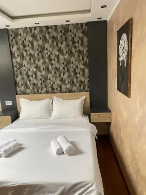a bedroom with a bed with two towels on it at Apartmani Mali vikend in Belgrade