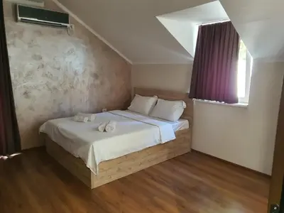 a bedroom with a bed with two towels on it at Apartmani Mali vikend in Belgrade
