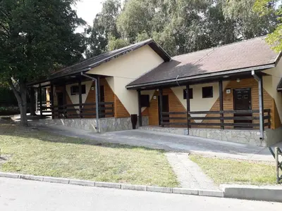 a large wooden building with a garage at Hotel Marina Agreena in Grocka