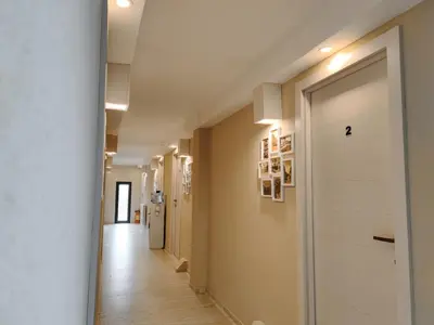 a hallway with a white door in a building at Hotel Marina Agreena in Grocka