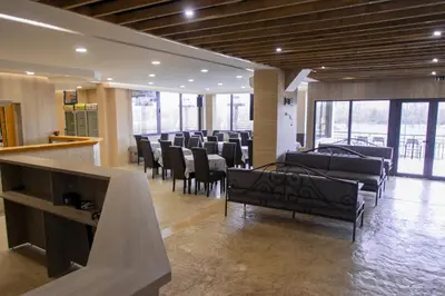 a waiting room with chairs and tables and windows at Hotel Marina Agreena in Grocka