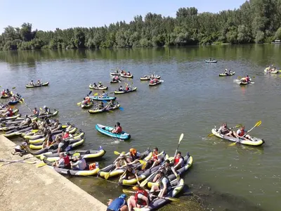 a large group of people kayaking on a river at Hotel Marina Agreena in Grocka