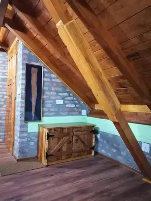 a room in a log cabin with wooden beams at Kućerak X in Ruma