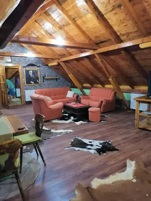 a living room with two couches and a table at Kućerak X in Ruma