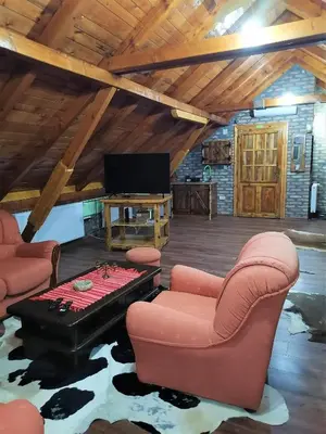 a living room with a ping pong table and chairs at Kućerak X in Ruma