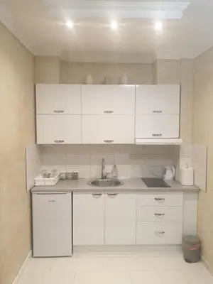 a kitchen with white cabinets and a sink at Elena Lux in Belgrade