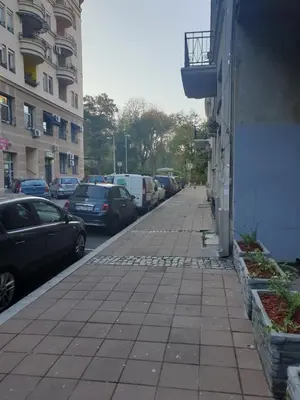a street with cars parked on the side of a building at Elena Lux in Belgrade