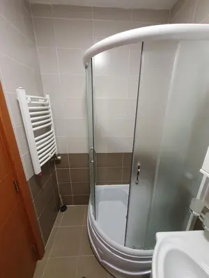 a shower with a glass door in a bathroom at Raven2 in Železnik