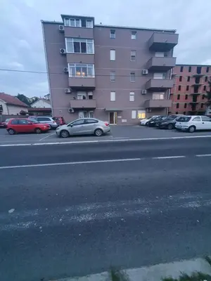 a parking lot with cars parked in front of a building at Raven2 in Železnik