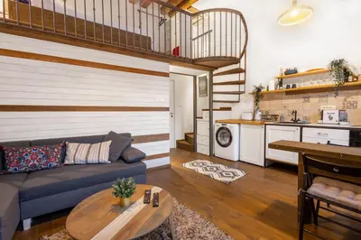 a living room with a couch and a table at Old Port Riverside Apartments in City Center in Belgrade