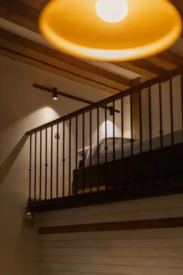 a ceiling with a chandelier and a bed on a balcony at Old Port Riverside Apartments in City Center in Belgrade