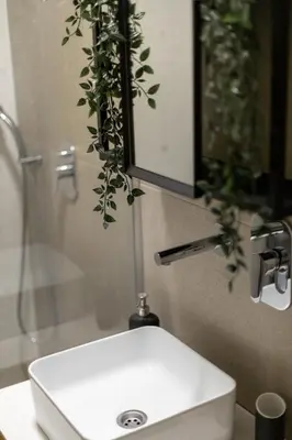 a bathroom with a white sink and a mirror at Old Port Riverside Apartments in City Center in Belgrade