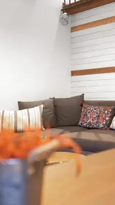 a living room with a couch and a table at Old Port Riverside Apartments in City Center in Belgrade