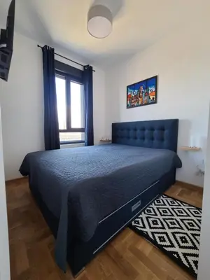 a bedroom with a blue bed in a room at Bella Vita Dorćol in Belgrade