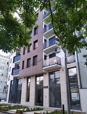 an apartment building with a balcony on a street at Bella Vita Dorćol in Belgrade
