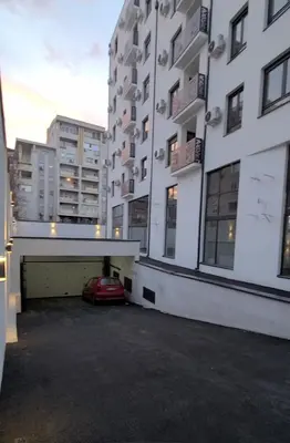 a car parked in a parking lot between two buildings at Bella Vita Dorćol in Belgrade