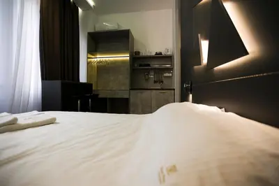 a bedroom with a large white bed in a room at East & West Apartments in Belgrade