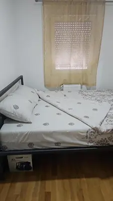 a bed in a bedroom with a window at Relax, apartman sa garažnim mestom in Obrenovac