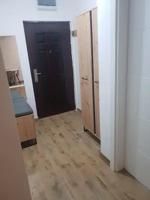 a room with a black door and a wooden floor at Relax, apartman sa garažnim mestom in Obrenovac