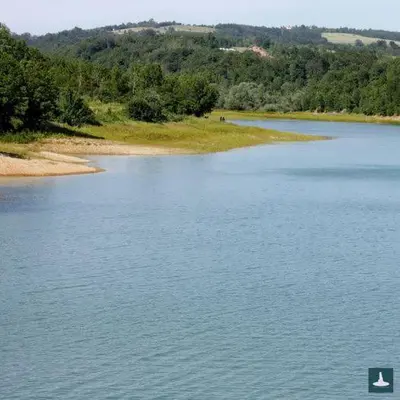 a large body of water with trees in the background at Apartman Panorama Arandjelovac in Arandjelovac