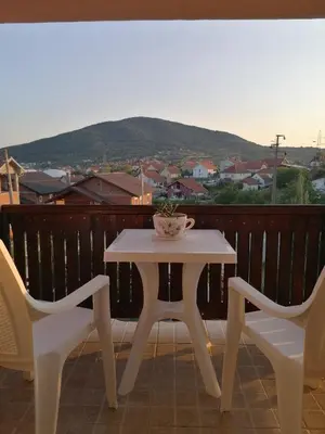 a white table and two chairs on a balcony at Apartman Panorama Arandjelovac in Arandjelovac