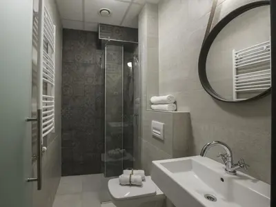 a bathroom with a sink and a shower and a mirror at Savamala b&b in Belgrade