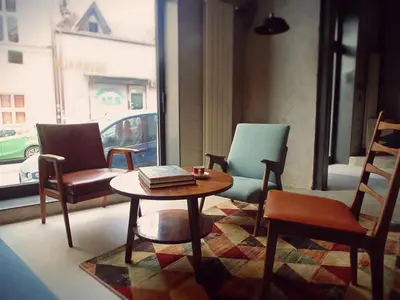 a room with three chairs and a table and a coffee table at Savamala b&b in Belgrade