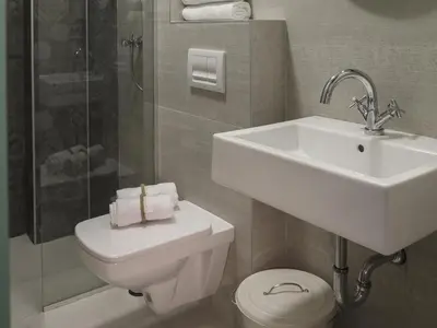 a bathroom with a sink and a toilet and a shower at Savamala b&b in Belgrade
