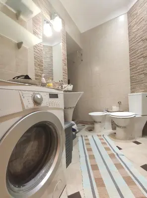a bathroom with a washing machine and a toilet at Skorpion in Belgrade