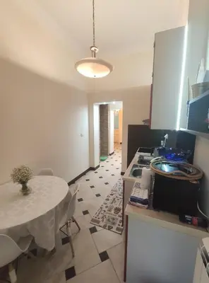 a kitchen with a white table and a table and a table and a table at Skorpion in Belgrade