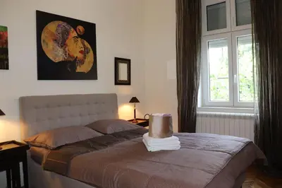 a bedroom with a bed and a window at Skorpion in Belgrade