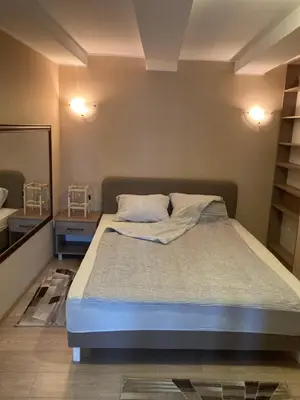 a bedroom with a bed and a mirror in it at House Apartment in Pančevo