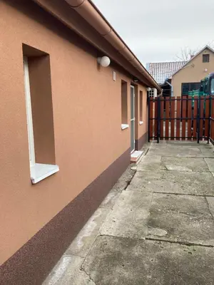 a brown building with a window on the side of it at House Apartment in Pančevo