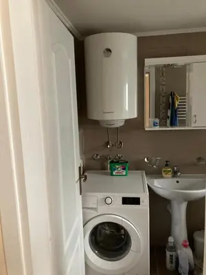 a bathroom with a washing machine and a sink at House Apartment in Pančevo