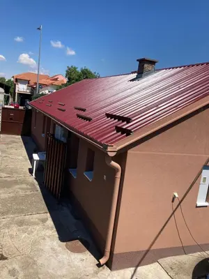 a building with a red roof on top of it at House Apartment in Pančevo