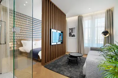 a hotel room with a bed and a glass wall at Dominic Smart & Luxury Suites - Edition in Belgrade