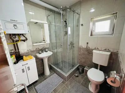a bathroom with a shower and a toilet and a sink at Helena apartment in Belgrade