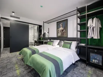 a bedroom with two beds and a tv in it at Joy 5 Hotel & SPA in Belgrade