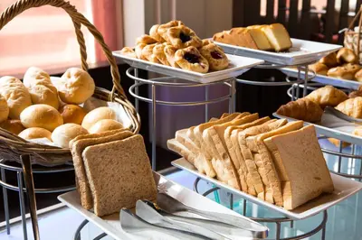 a display of bread and pastries on trays at Joy 5 Hotel & SPA in Belgrade