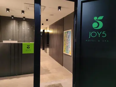 a door with a sign on it in a hallway at Joy 5 Hotel & SPA in Belgrade