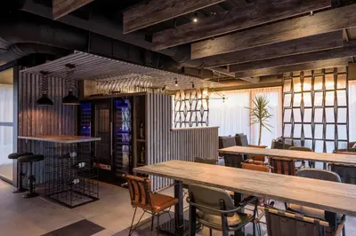 a dining room with wooden tables and chairs at Joy 5 Hotel & SPA in Belgrade
