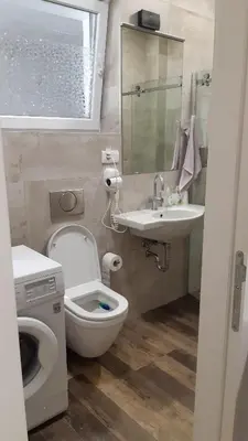 a small bathroom with a toilet and a sink at Cozy apartment in the center of Belgrade - living room, bedroom and bathroom in Belgrade