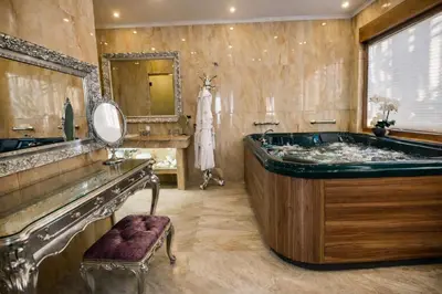 a large bathroom with a tub and a mirror at Prezident Palace Belgrade - Luxury Boutique Hotel & Spa in Belgrade