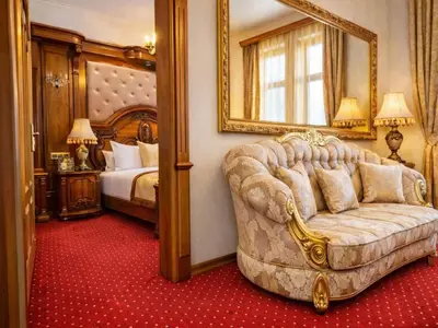 a bedroom with a couch and a bed with a mirror at Prezident Palace Belgrade - Luxury Boutique Hotel & Spa in Belgrade